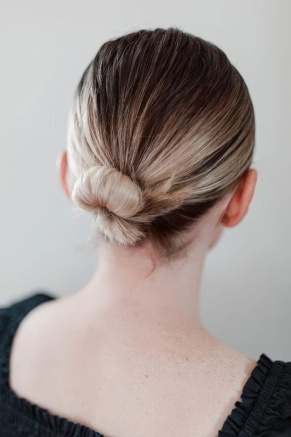 Sleek low wrapped bun with a sleek top.