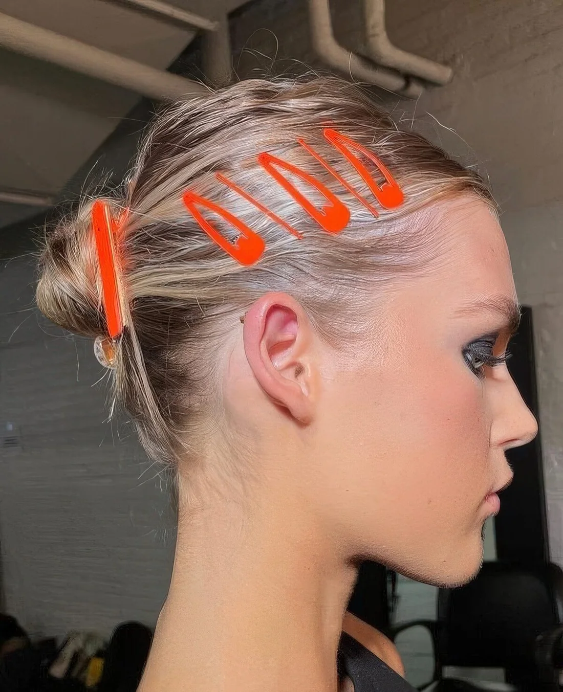 Small midi bun accented witha red barrette and matching hair pieces.