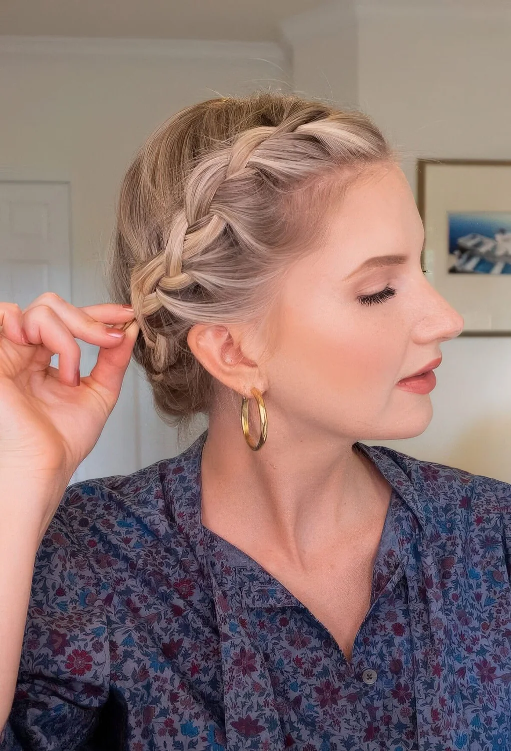 Blonde bob styled with a crown braid, which.