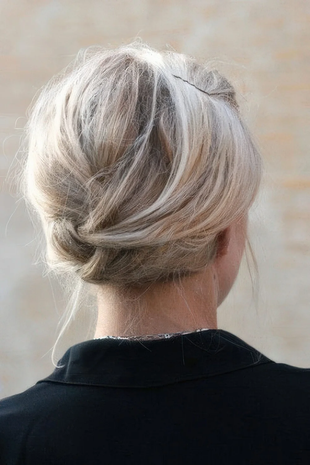 Braided low updo with a bump on top.