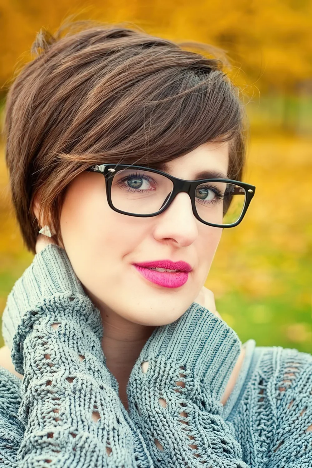 Long layered pixie haircut with side bangs.