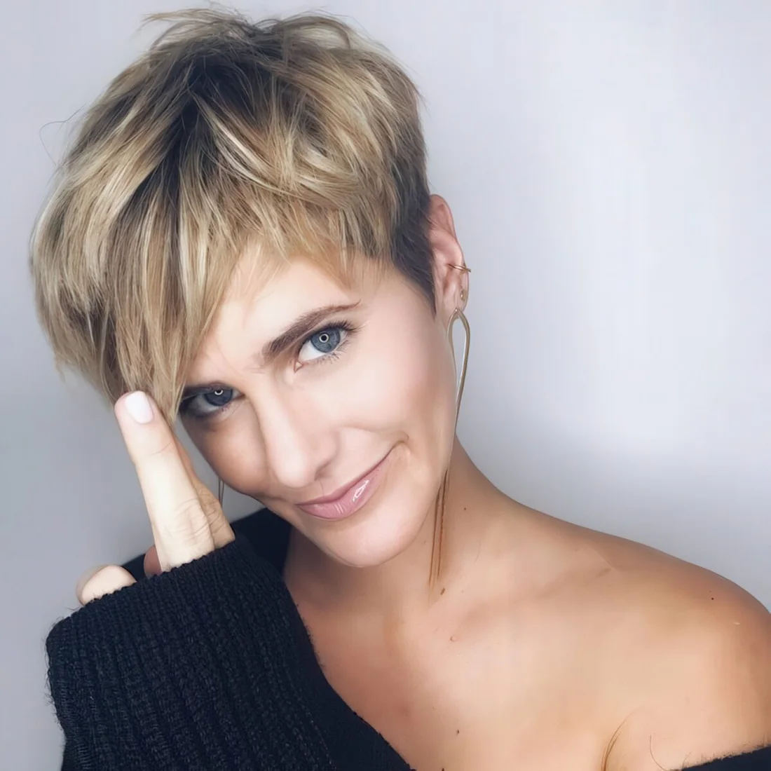 Chic and edgy layered pixie haircut with blonde balayage.