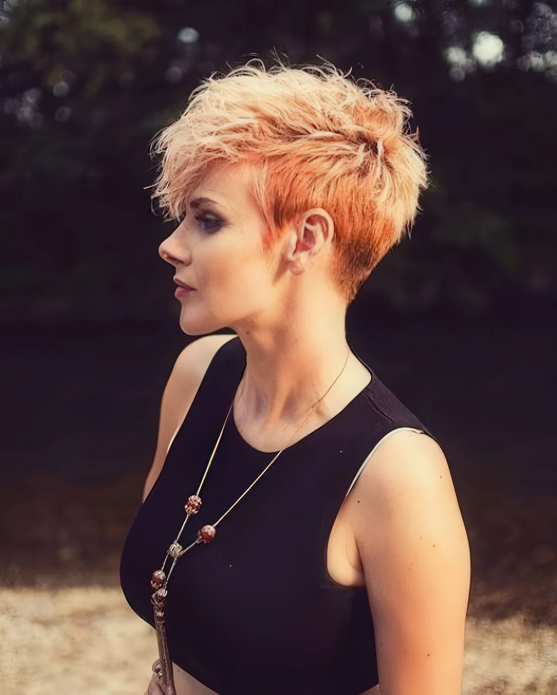 Textured and bold pixie haircut with a bold color and balayage.
