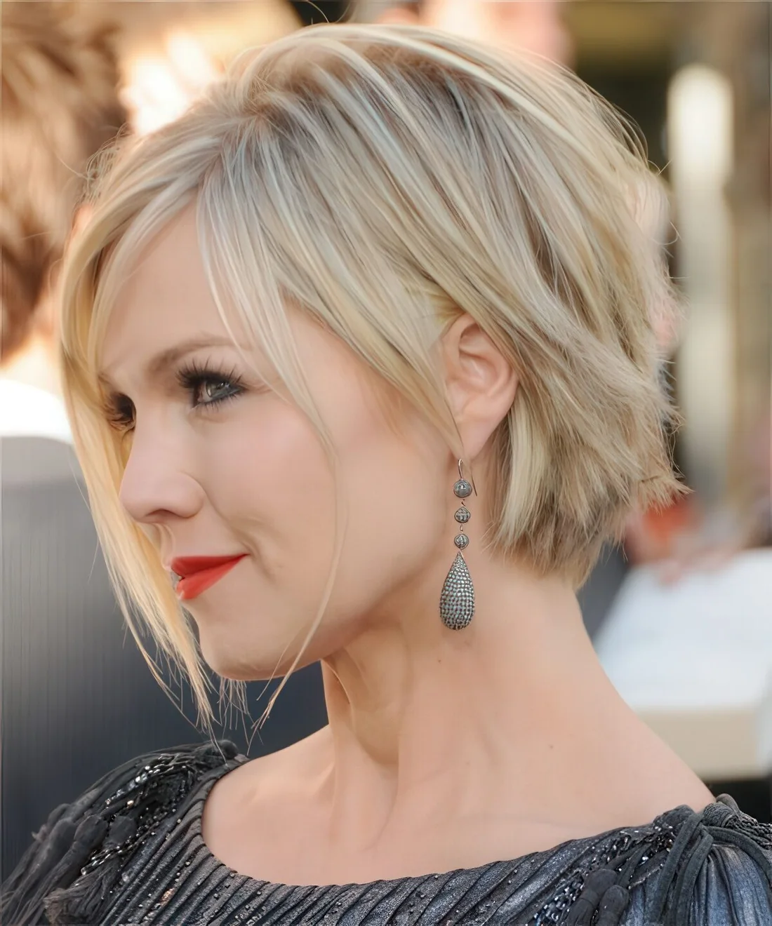 Short bob with bangs and raored layers plus a beautiful blonde balayage.