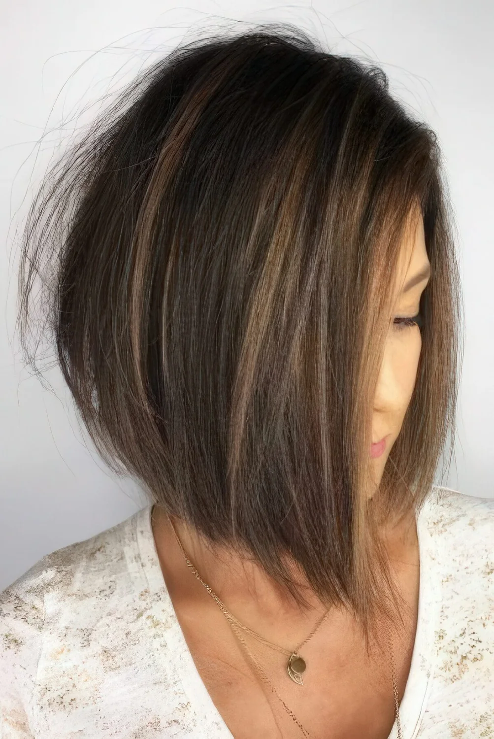 Angled short bob with some highlights.