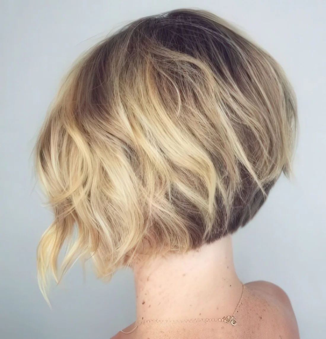Photo showing short wavy inverted bob, with the hairstyle clearly visible.