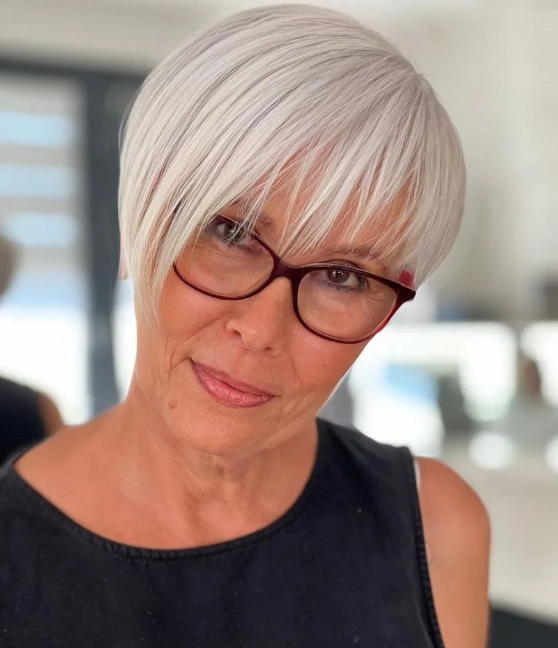 ear straight gray pixie with side swept fringe shown as a short haircuts for women over 60 idea, featuring gray color