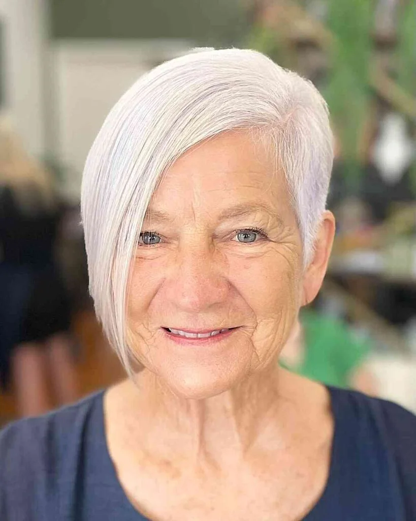 chin straight gray bob with side swept fringe shown as a short haircuts for women over 70 idea