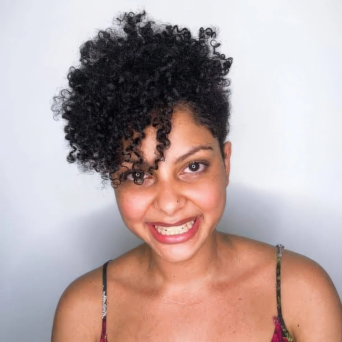 Photo showing short curly hairstyle, with the hairstyle clearly visible.