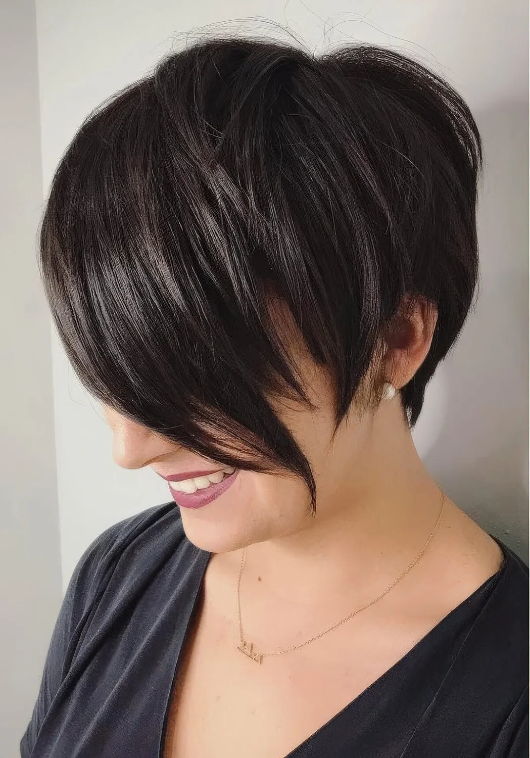 Asymmetrical pixie cut with long bangs.