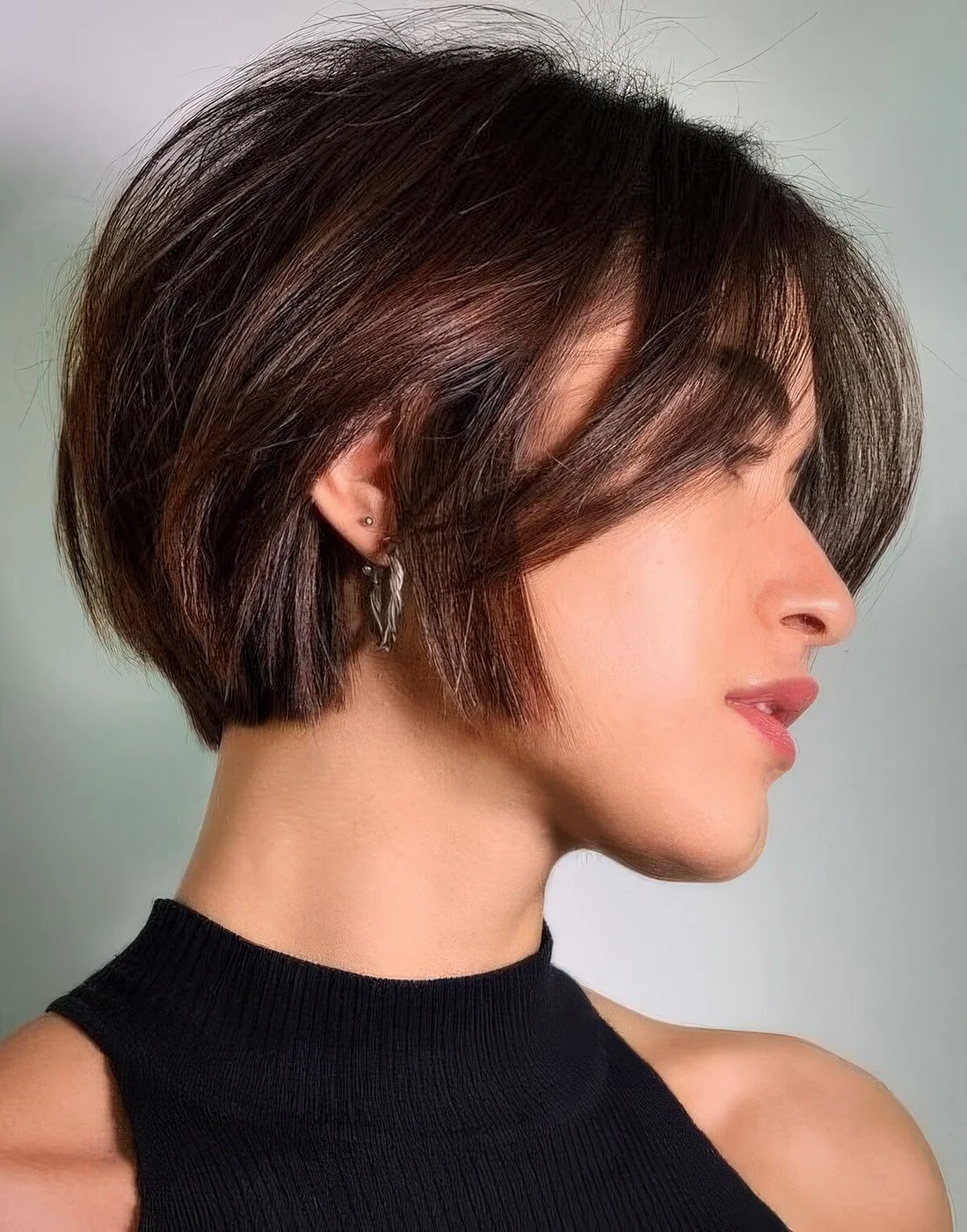 Short and textural bob with bangs in a beautiful chestnut shade.