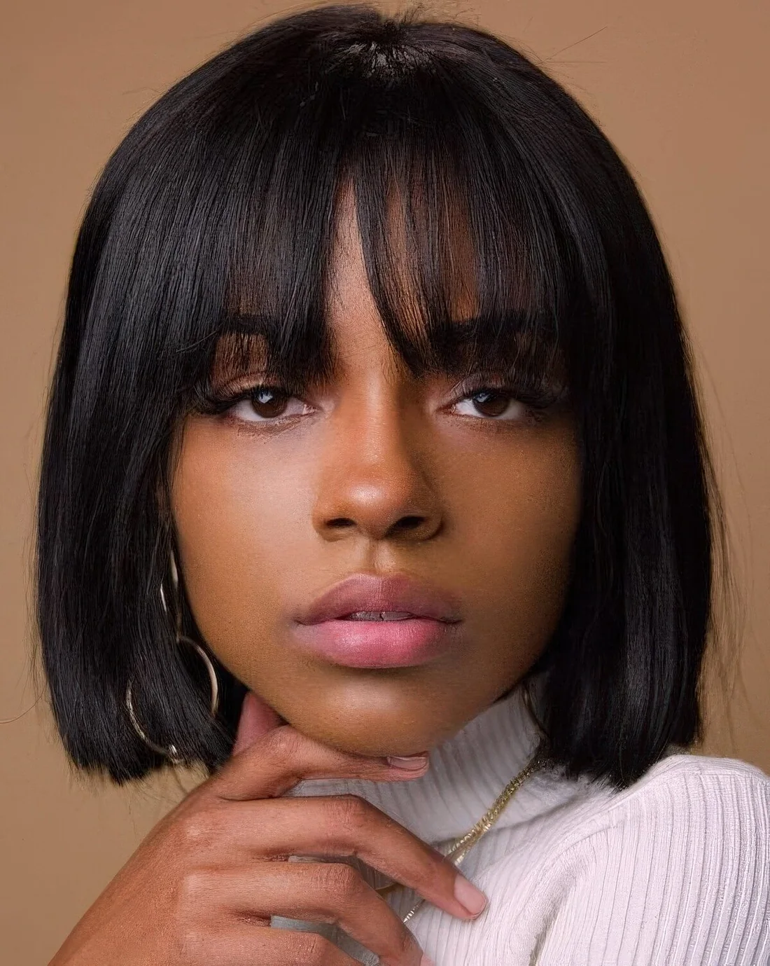 Short black bob with outgrown bangs.
