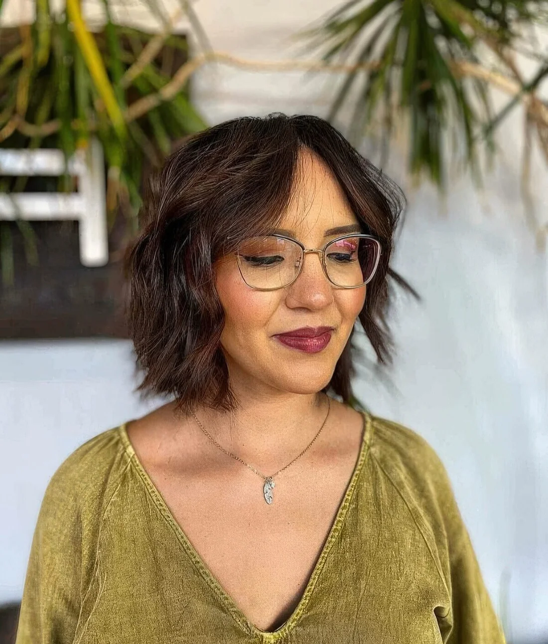 Short textured bob with center part and a soft curtain fringe.