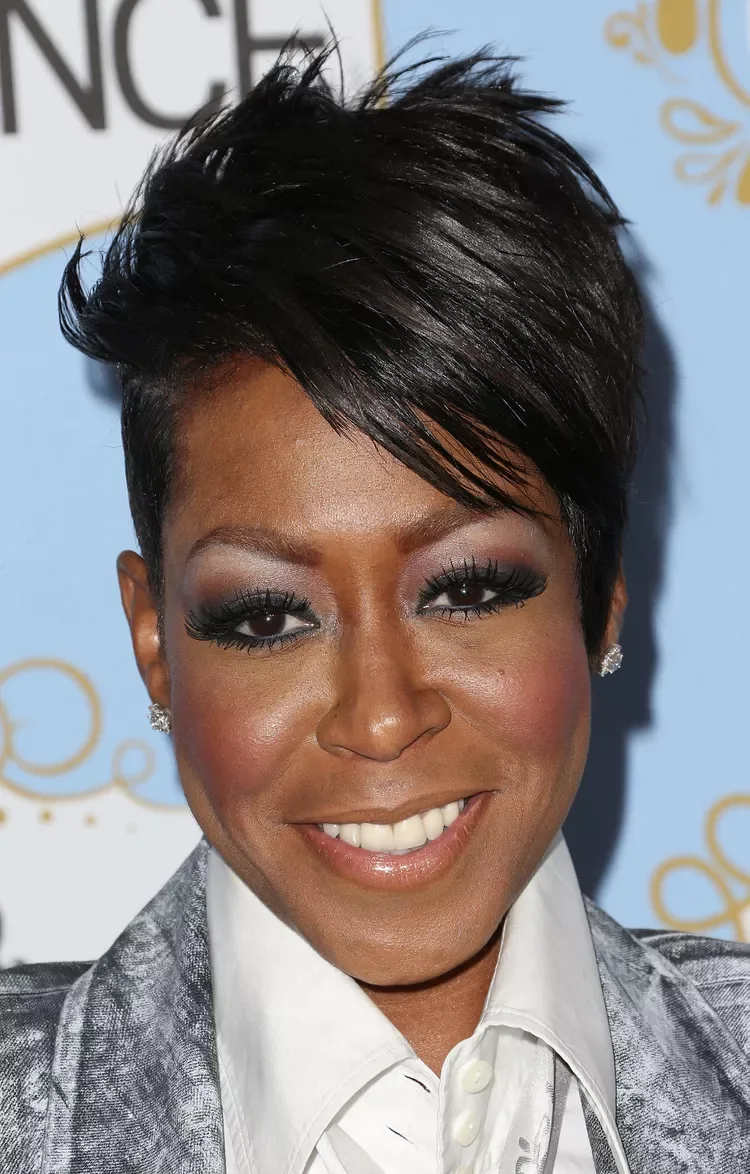 ear straight black pixie with side swept fringe shown as a short hairstyles for older black women idea, featuring center part
