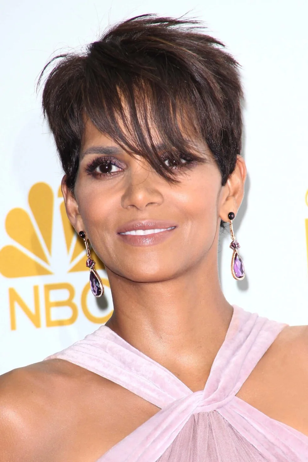 ear straight chestnut pixie with side swept fringe shown as a short hairstyles for thin hair and round face idea, featuring chestnut color, shown in brunette pixie with long fringe