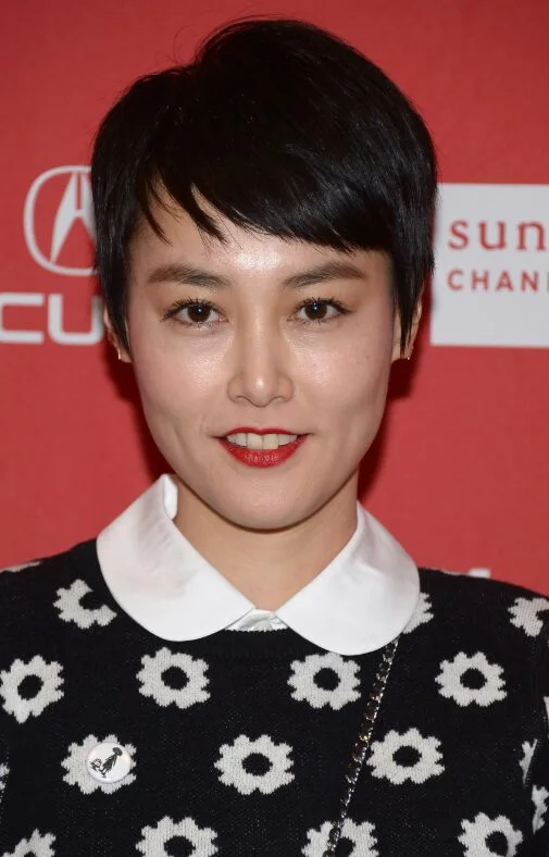ear straight chestnut pixie with side swept fringe shown as a short hairstyles for thin hair and round face idea, featuring medium layering, shown in black micro pixie with short fringe