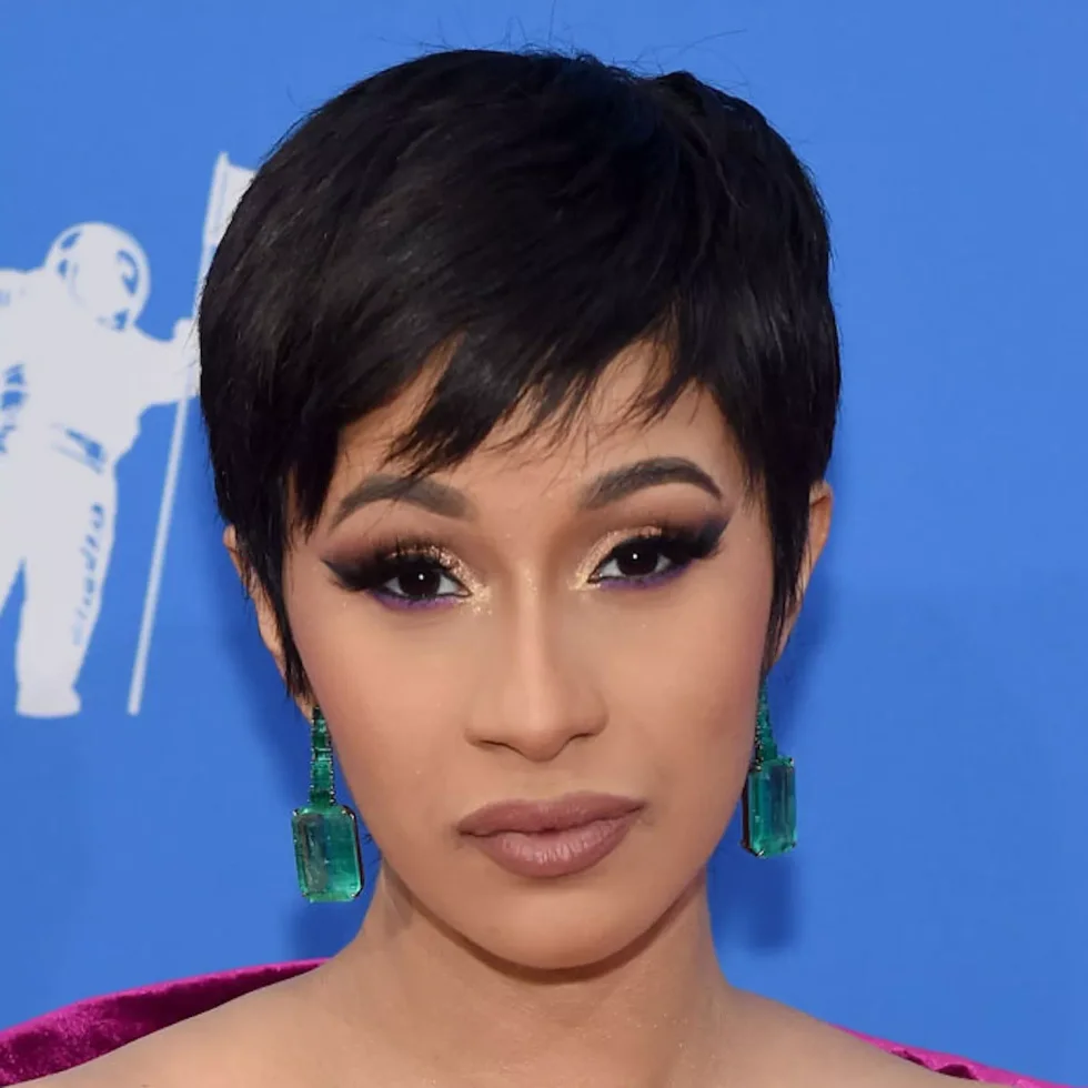 ear straight black pixie with side swept fringe shown as a short hairstyles for thin hair and round face idea
