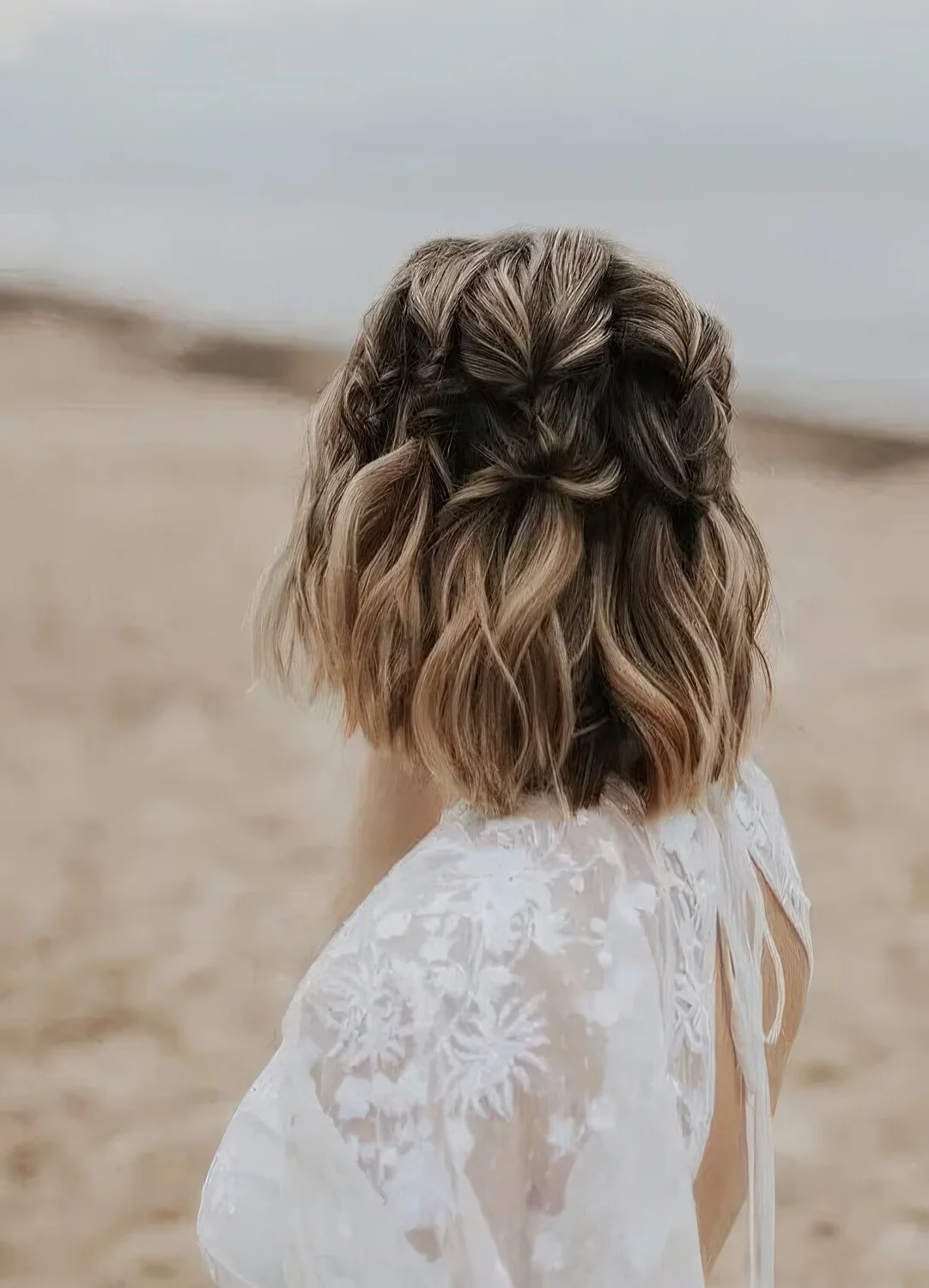 Brown long bob with blonde and caramel balayage and braids all over the head.