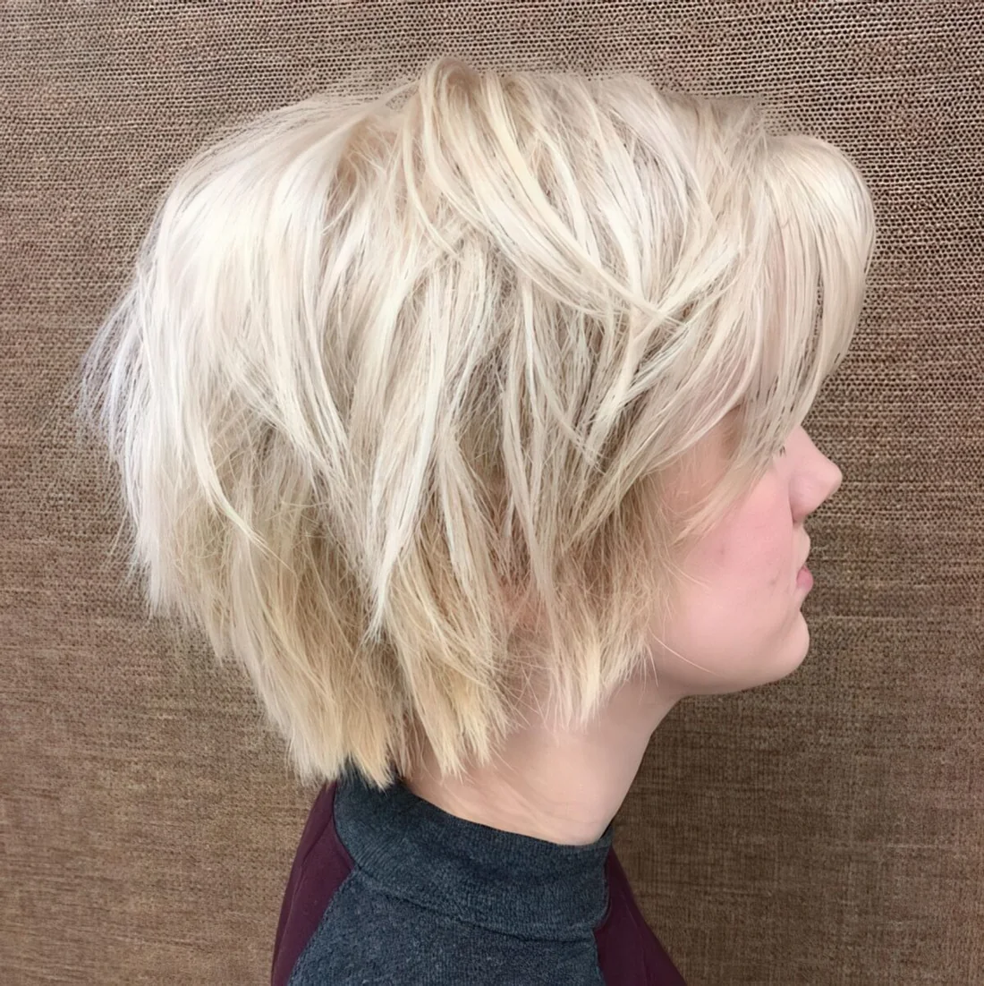 Photo showing wispy layered platinu blonde bob, with the hairstyle clearly visible.