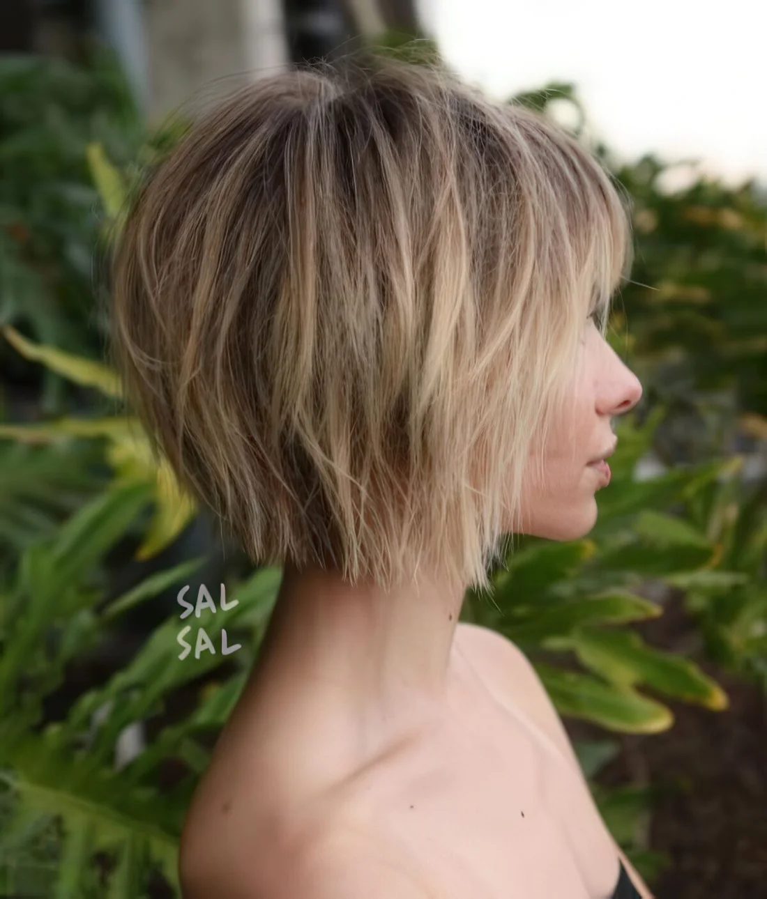 Short choppy bob with bangs and a slight balayage.