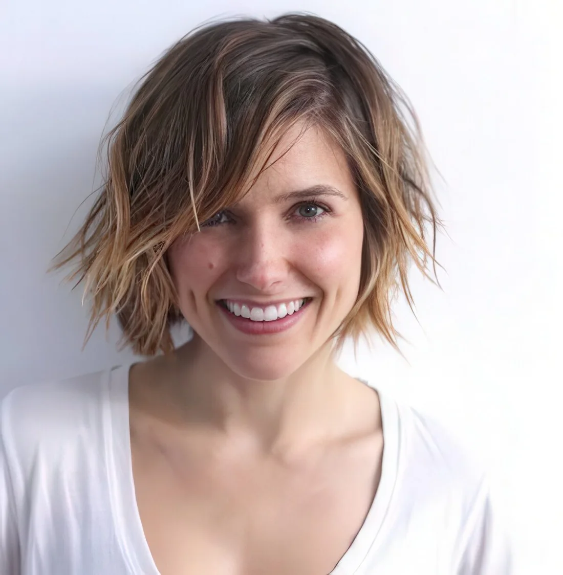 Short shaggy layered haircut with balayage and messy waves for an edgy look.