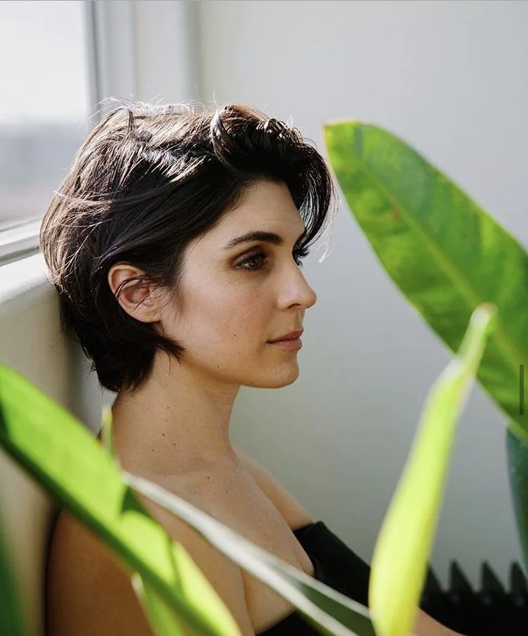 Photo showing dark brunette bixie, with the hairstyle clearly visible.