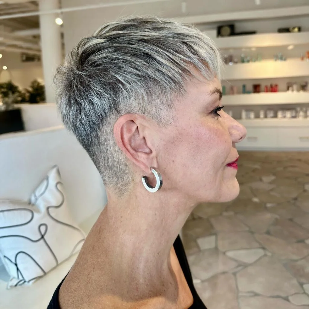 ear straight silver pixie with side swept fringe shown as a short pixie haircuts for older women idea, featuring straight texture