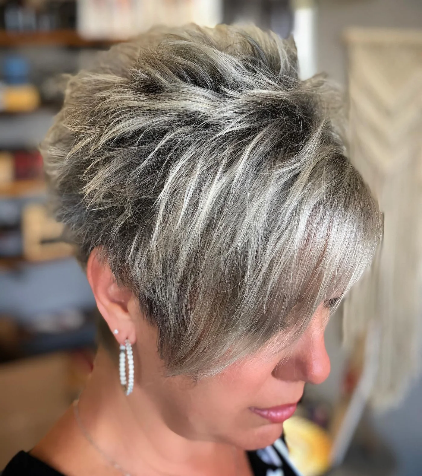 ear straight silver pixie with side swept fringe shown as a short pixie haircuts for older women idea, featuring side swept fringe