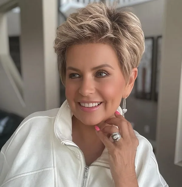 ear straight silver pixie with side swept fringe shown as a short pixie haircuts for older women idea, featuring side part