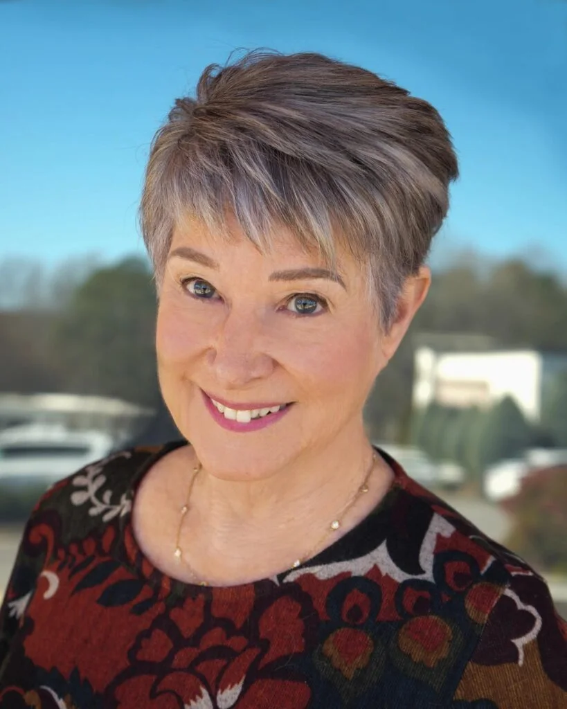 ear straight golden pixie with wispy fringe shown as a short pixie haircuts for older women idea