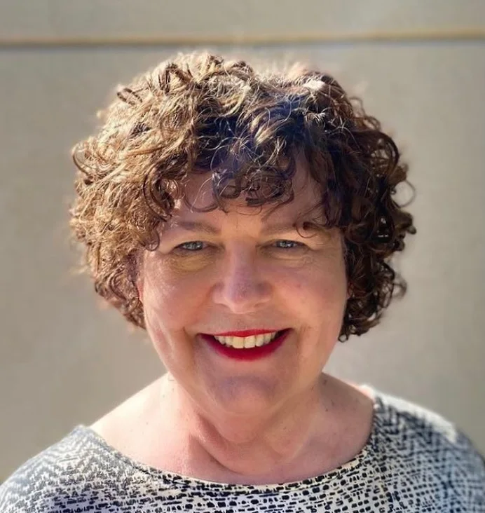 ear curly chestnut curly bob with curly fringe fringe shown as a short pixie haircuts for older women idea