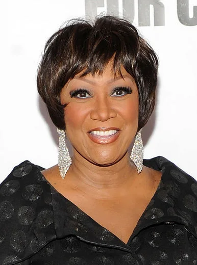 ear straight black pixie with side swept fringe shown as a short pixie haircuts for older women idea