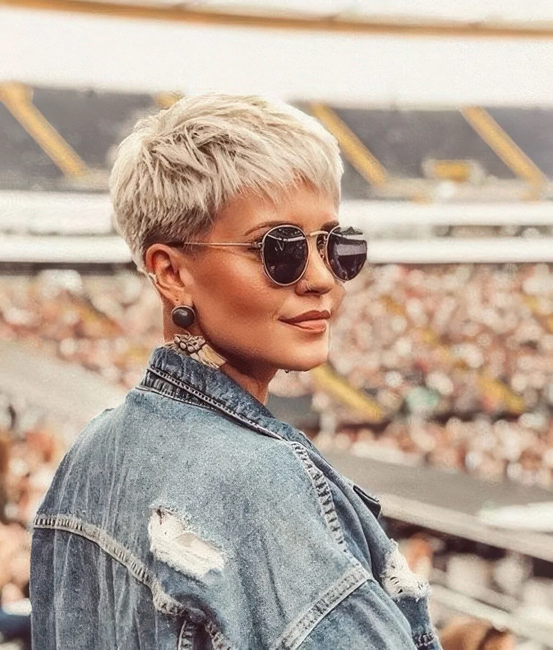Photo showing blonde layered short pixie, with the hairstyle clearly visible.