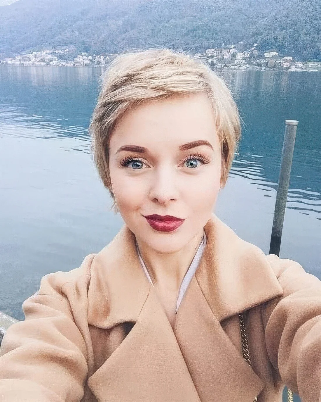 Short blonde pixie with side part and a lot of texture and volume.