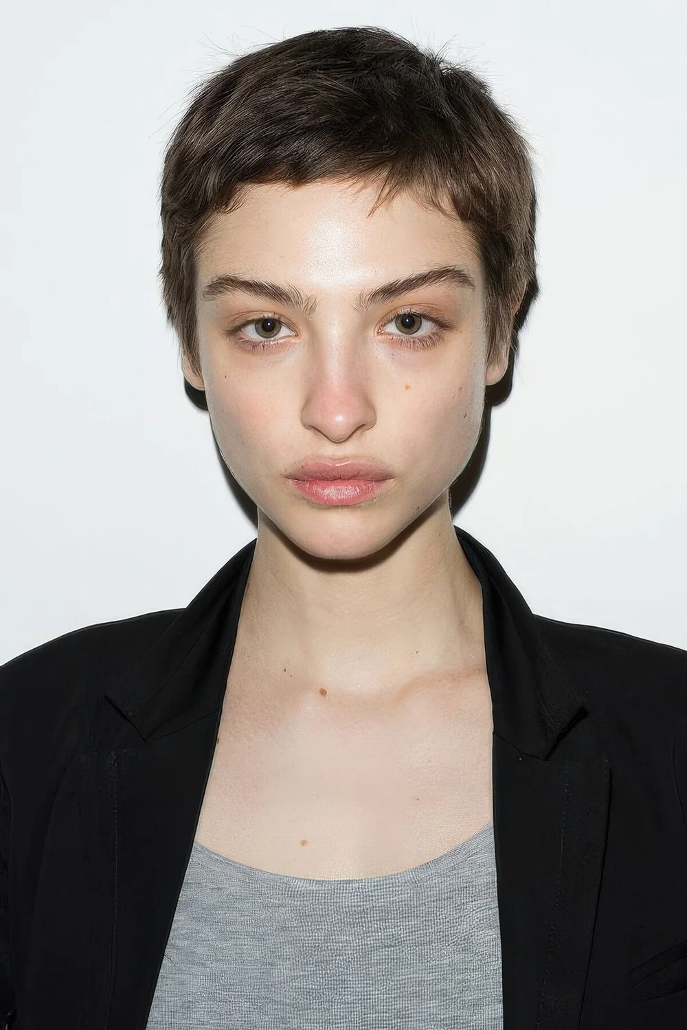 Photo showing short brunette pixie, with the hairstyle clearly visible.