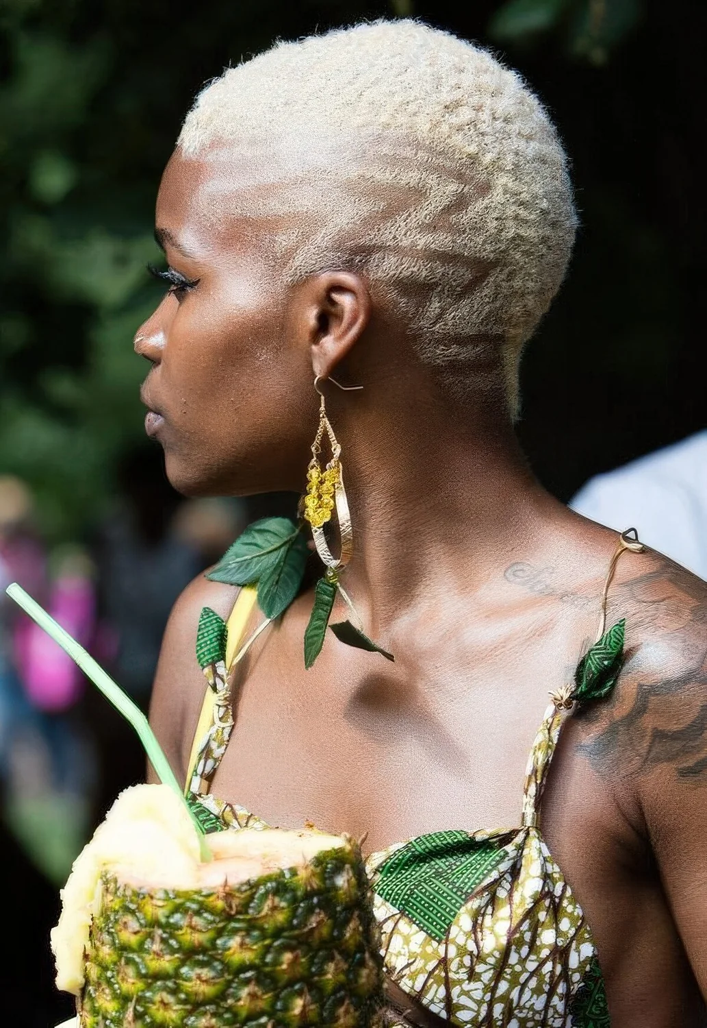 Very short blonde pixie haircut with a geometric touch for an edgy feel.