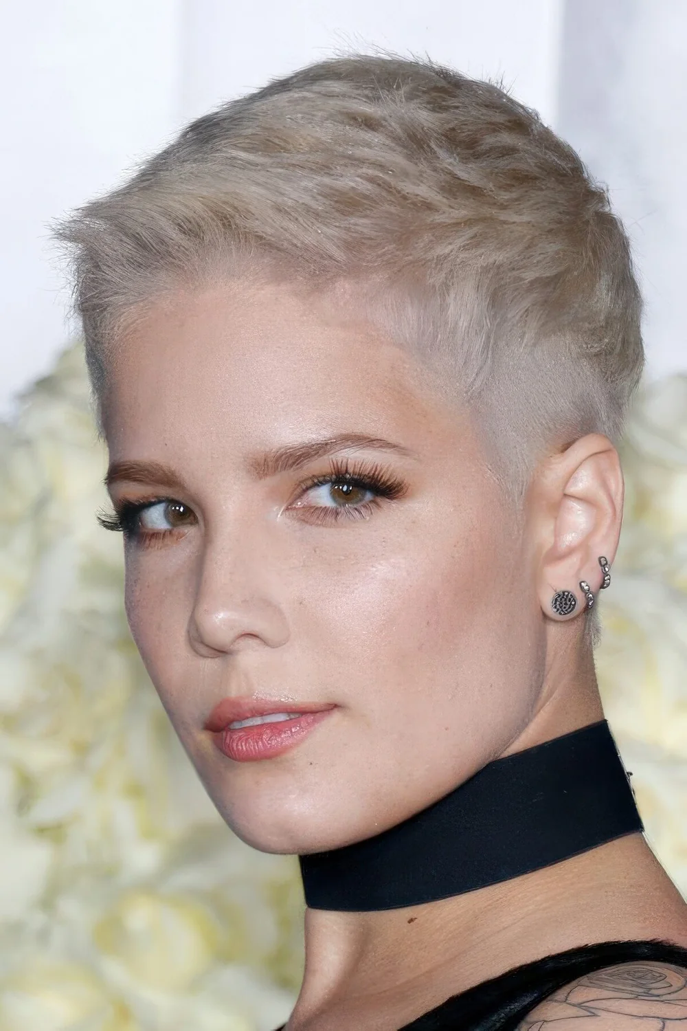 Ash blonde short pixie cut with raised up locks.