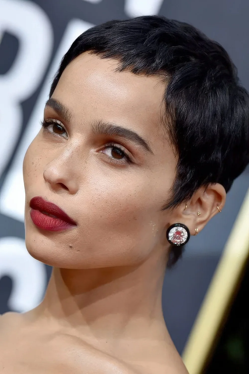 Zoe Kravitz wearing a short black pixie cut.