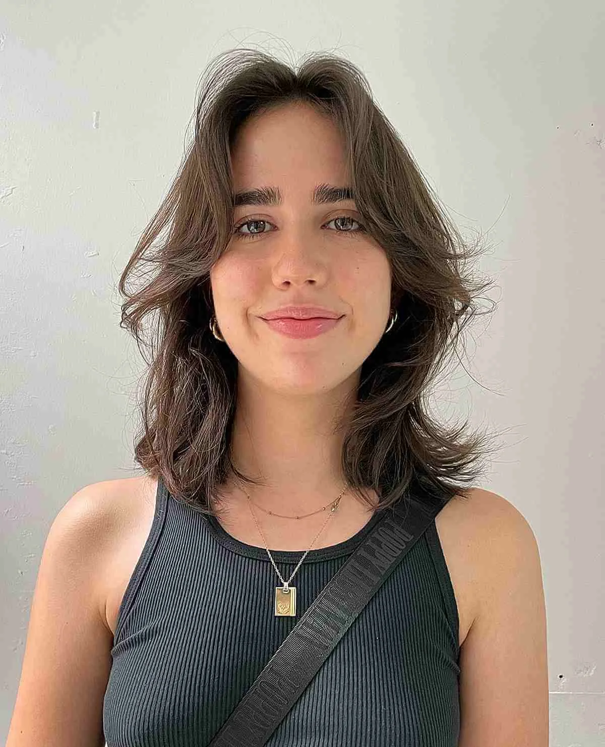 neck wavy brunette shag with curtain fringe shown as a short shaggy hair idea