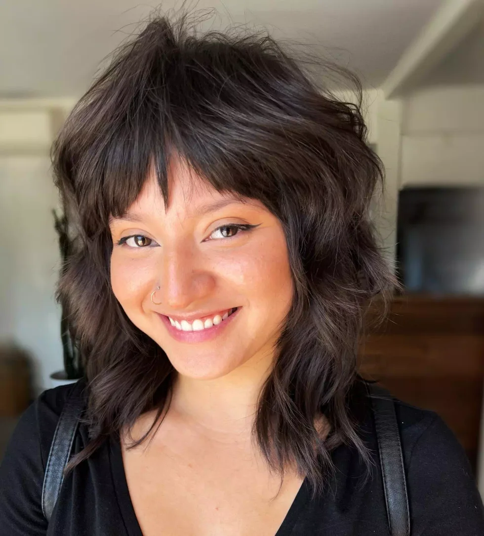 medium wavy brunette shag with micro fringe shown as a short wolf curtain bangs idea