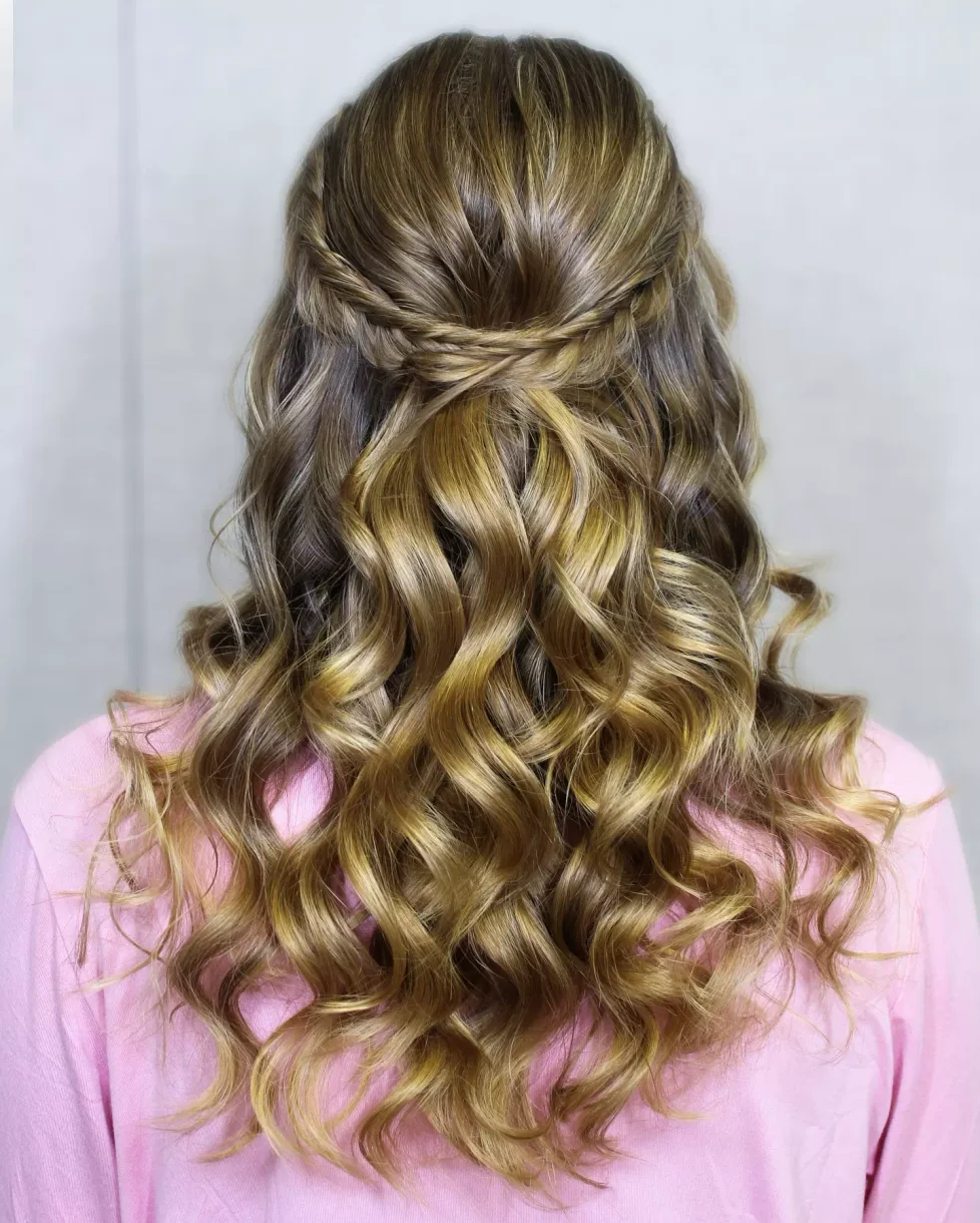 chest braids black fulani shown as a simple wedding guest hair idea, featuring black color, shown in golden easy half-up curls