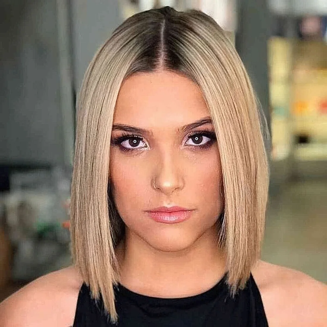 Blonde slob with sharp edges. a darker root and limp tresses.