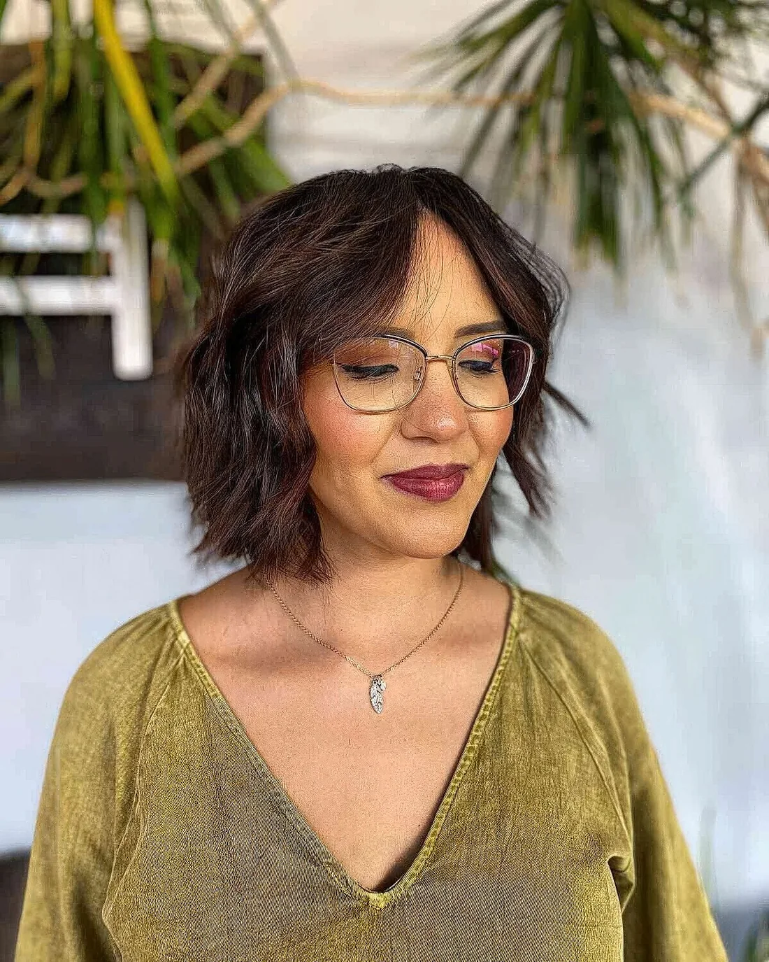 Short textured bob with center part and a soft curtain fringe.