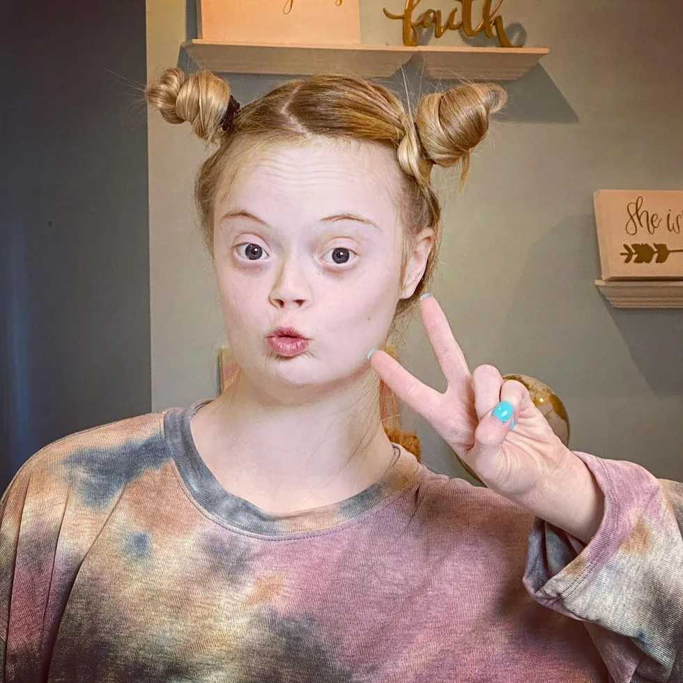 shoulder straight brunette bun with blunt fringe shown as a space buns idea