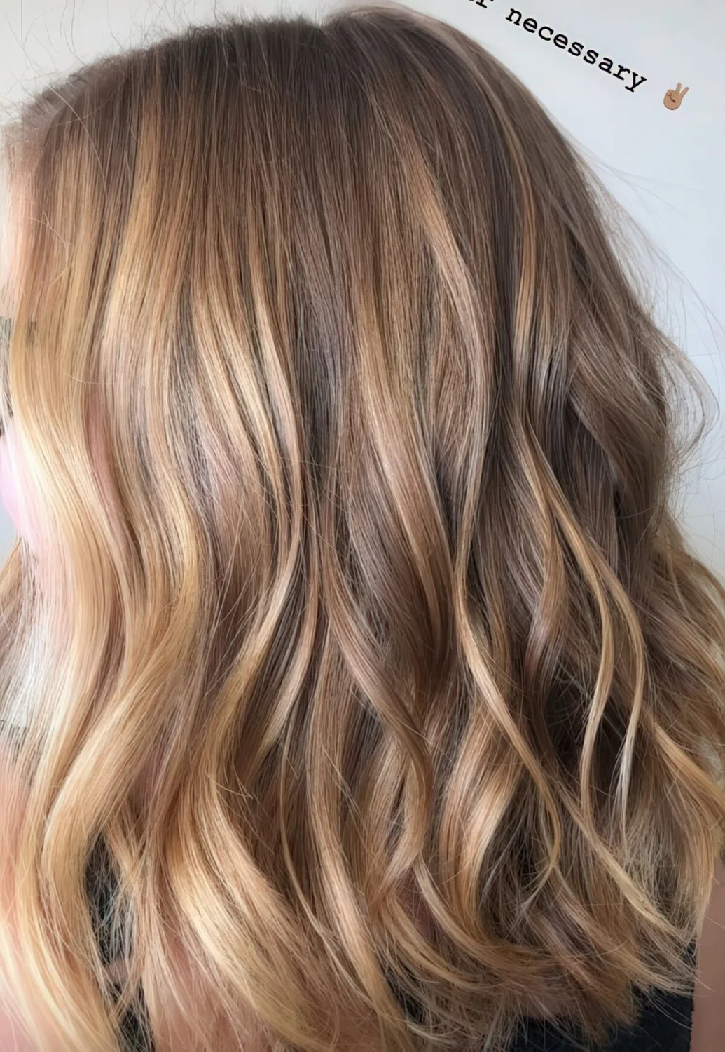Light brunette hair with blonde and sunkissed balayage and waves.