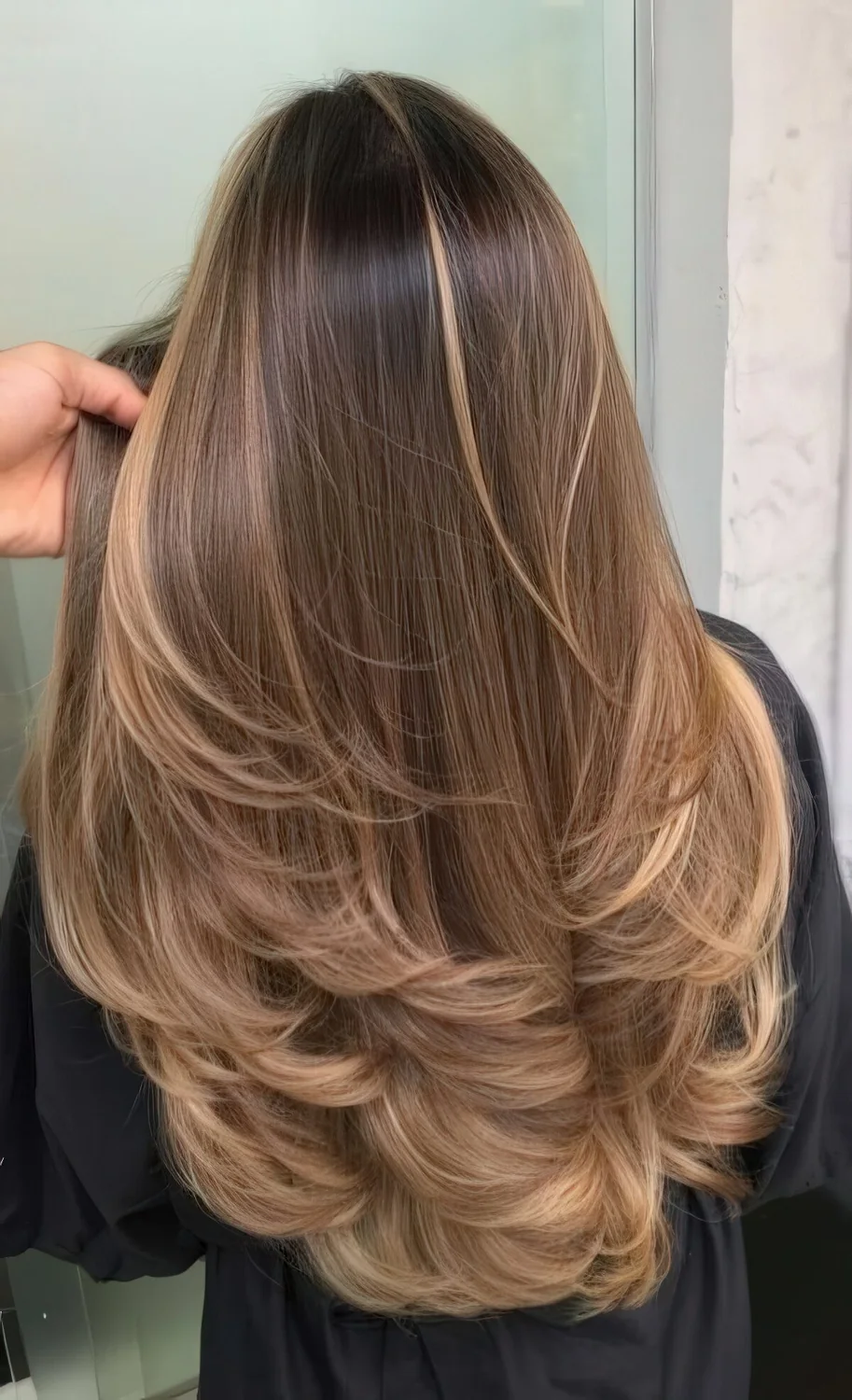 Long brown hair with long sunkissed and mushroom blonde balayage and a bit of ombre.