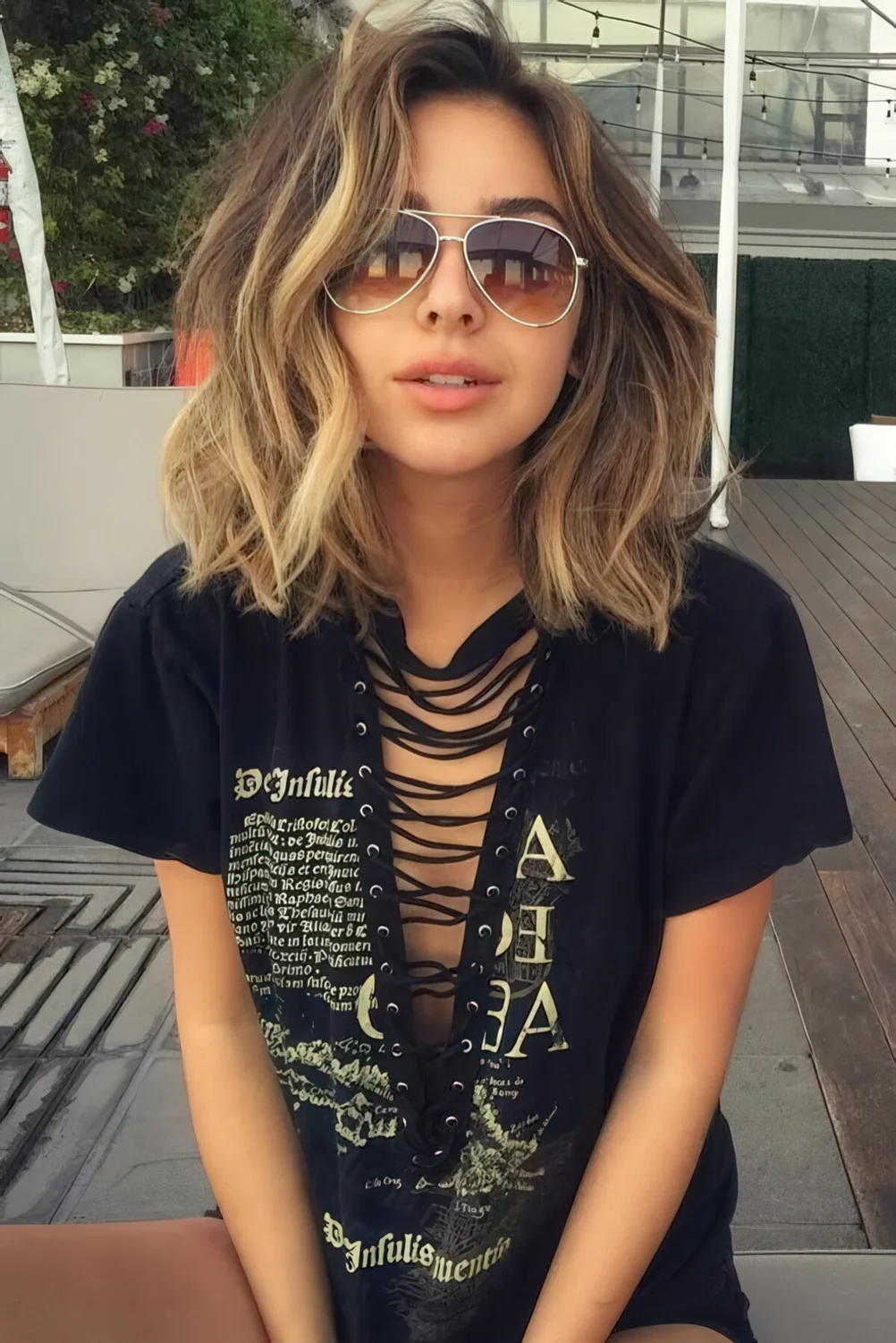 Rich brown shoulder-length hair with sunkissed highlights and light waves plus volume for a summer loving look.