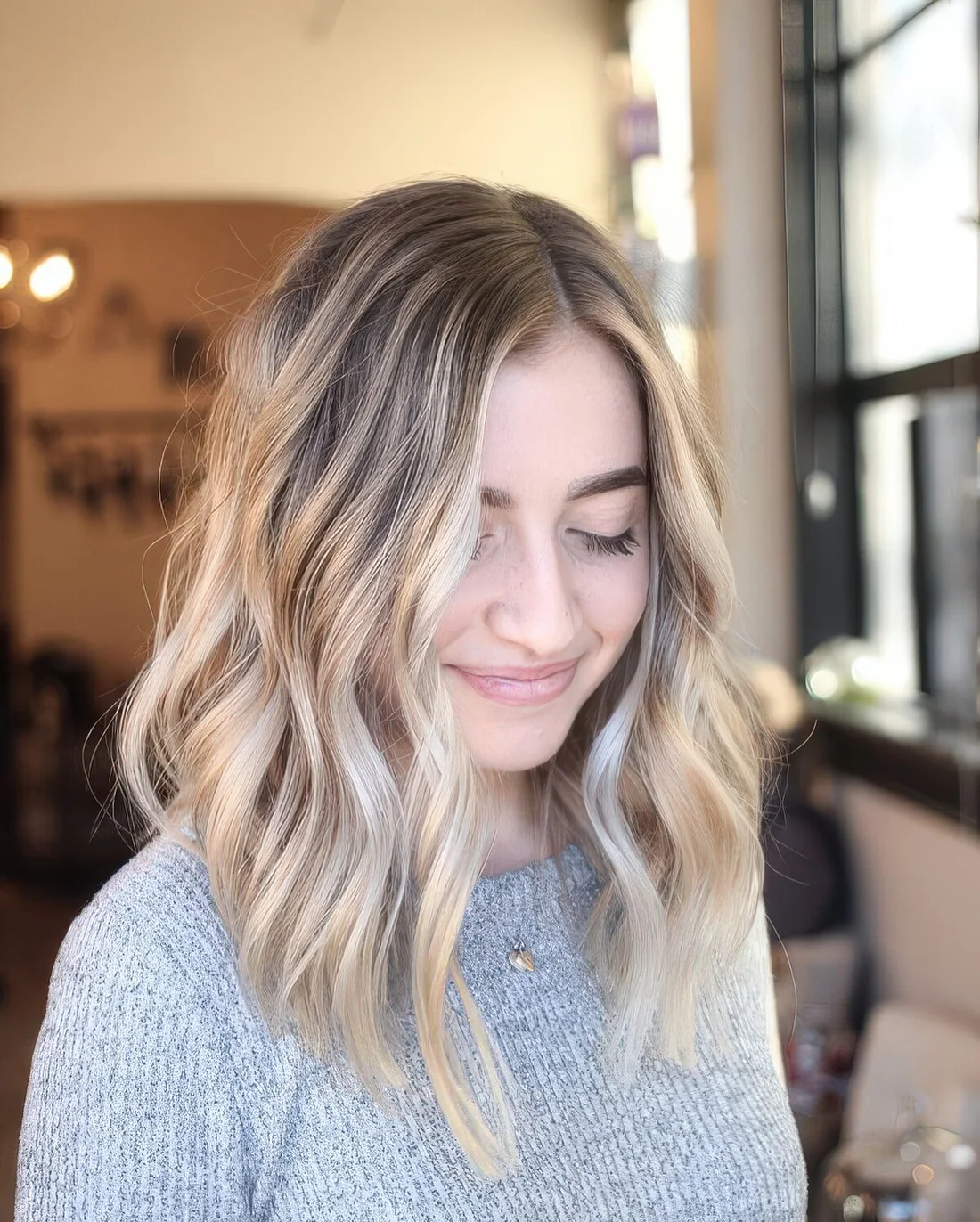 Sunkissed blonde with waves and a slightly darker root.