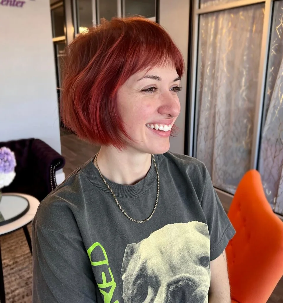 jaw wavy copper bob with side swept fringe shown as a textured bob for thin hair idea
