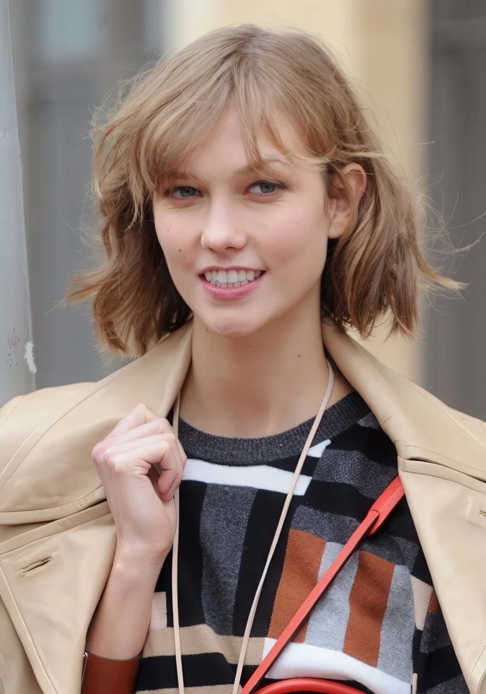 Choppy blonde wavy lob with side-swept bangs.